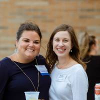 Two guests posing for a photo at the celebration event.